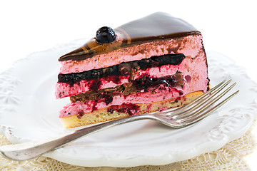 Image showing Piece of cake with soufflé and fork on a white plate.