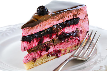 Image showing Piece of cake with souffle and jelly berries close up.