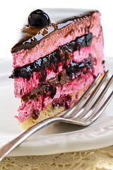 Image showing Souffle cake with jelly berries and praline close up.