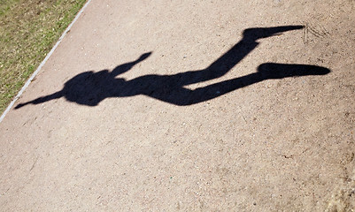 Image showing human shadow in flying jump