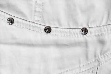 Image showing part of white jeans. macro photo