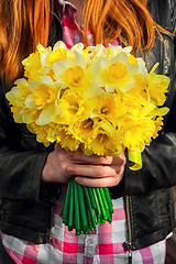 Image showing figure girl with bouquet of daffodils in his hands