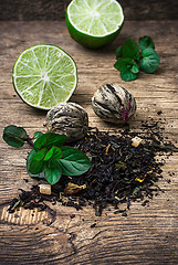 Image showing tea brew with lime and mint on wooden background 