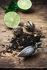 Image showing tea brew with lime and mint on wooden background 