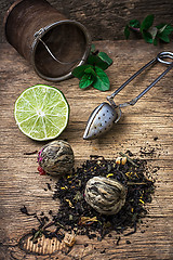 Image showing tea brew with lime and mint on wooden background 