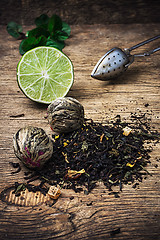 Image showing tea brew with lime and mint on wooden background 