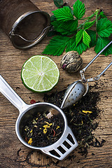 Image showing tea brew with lime and mint on wooden background 