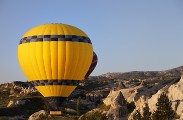 Image showing Hot air balloons in mountains at morning