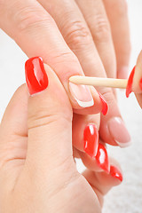 Image showing manicure applying - cleaning the cuticles 