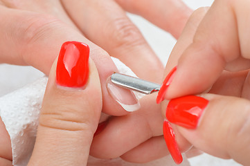 Image showing manicure applying - cleaning the cuticles 