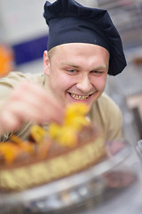 Image showing chef preparing desert cake in the kitchen