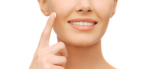 Image showing beautiful woman applying moisturizing cream