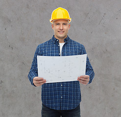 Image showing smiling male builder in helmet with blueprint