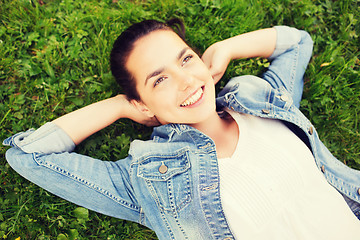 Image showing smiling young girl lying on grass