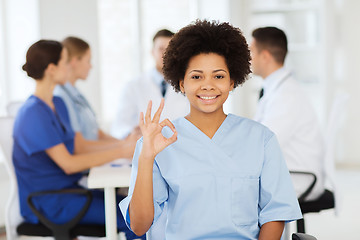 Image showing happy doctor over group of medics at hospital