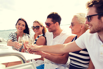 Image showing smiling friends with glasses of champagne on yacht