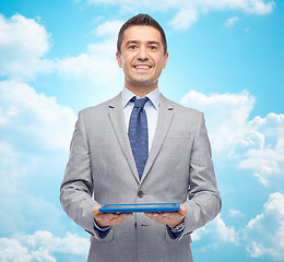 Image showing happy businessman in suit holding tablet pc