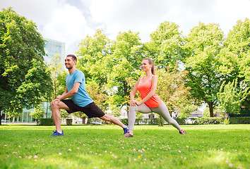 Image showing smiling couple stretching outdoors