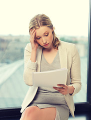 Image showing bored and tired woman with documents