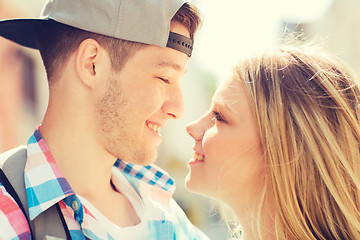 Image showing smiling couple with backpack in city