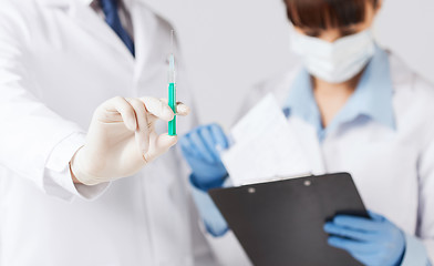 Image showing doctors with syringe