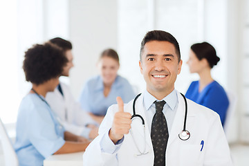 Image showing happy doctor over group of medics at hospital