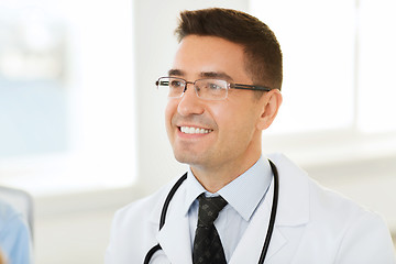 Image showing smiling male doctor in white coat and eyeglasses