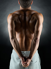 Image showing young male bodybuilder from back