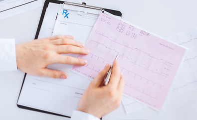 Image showing male doctor hands with cardiogram