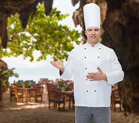 Image showing happy male chef cook inviting