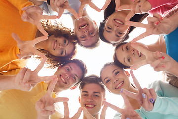 Image showing group of smiling teenagers showing victory sign