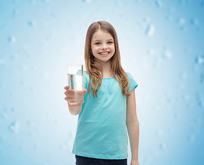 Image showing smiling little girl giving glass of water