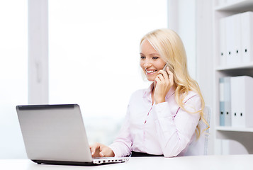 Image showing smiling businesswoman calling on smartphone