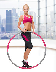 Image showing young sporty woman with hula hoop