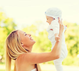 Image showing happy mother with little baby in park