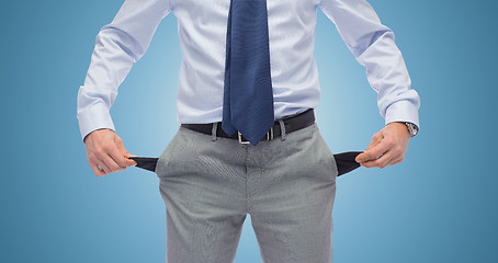 Image showing close up of businessman showing empty pockets