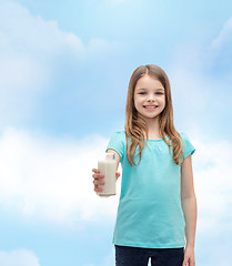 Image showing smiling little girl giving glass of milk