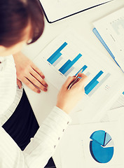 Image showing woman hand with charts and papers