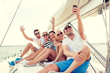 Image showing smiling friends sitting on yacht deck