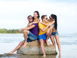 Image showing happy friends on summer beach