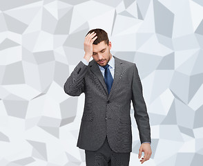 Image showing handsome businessman having headache