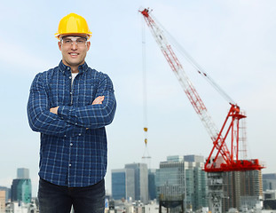 Image showing smiling male builder or manual worker in helmet