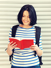 Image showing woman with bag and book