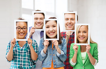 Image showing friends or students covering faces with papers