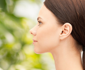 Image showing beautiful young woman face over green background