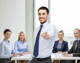 Image showing handsome businessman pointing finger at you