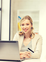 Image showing happy woman with laptop computer and credit card