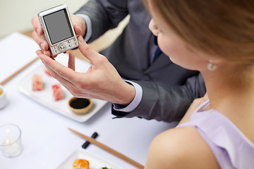 Image showing close up of couple with camera at restaurant