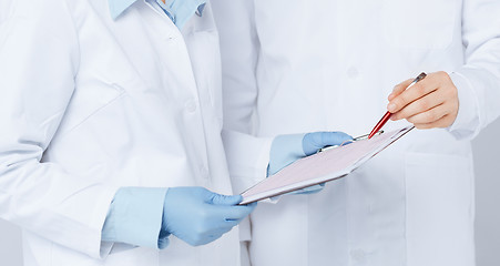 Image showing nurse and male doctor holding cardiogram