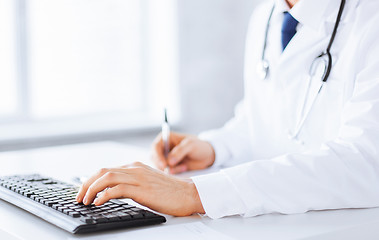 Image showing male doctor typing  on the keyboard